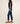 Person wearing blue jeans and red sneakers on a plain background