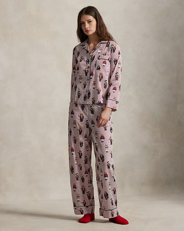 Woman wearing a patterned pajama set with red socks on a plain background