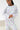 Person wearing a patterned pajama set on a white background