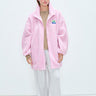 Person wearing a pink jacket with a visible brand logo on a white background