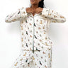 Woman wearing a white pajama set with animal prints on a white background